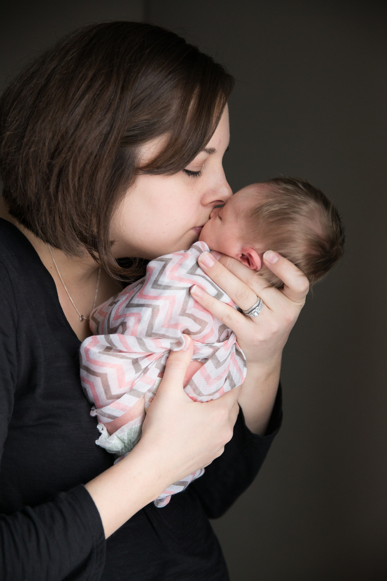 mom kissing baby