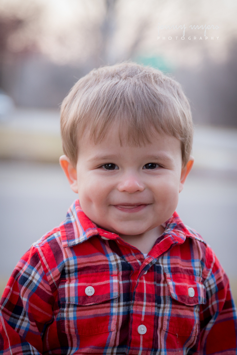 smile from a boy in a plaid shirt